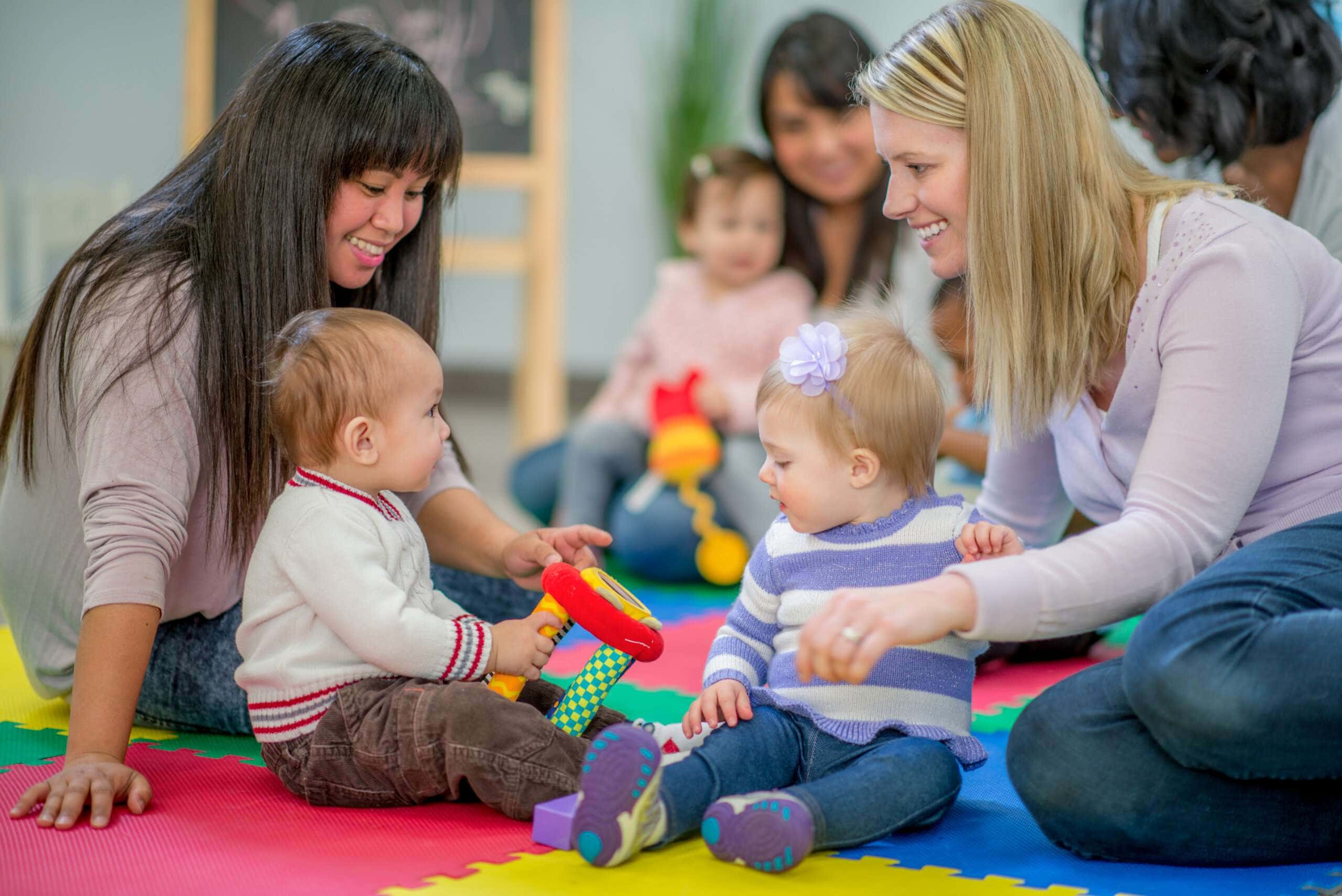 Infants playing in a rich learning environment during a Parent and Me class